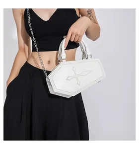 Detail of white coffin-shaped gothic crossbody bag with cross stitching and chain strap