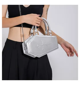 Detail of silver coffin-shaped handbag with cross stitching and metal chain strap