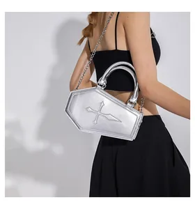 Gothic silver coffin bag with cross relief shown on a model with metal chain strap