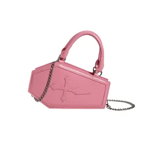 Pink coffin shaped handbag with cross detail and silver chain strap on white background