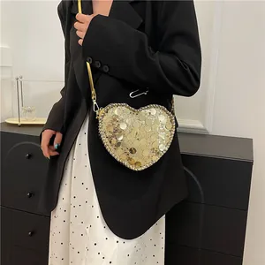 Fashionable heart-shaped crossbody bag with gold sequins and a slim metal chain strap