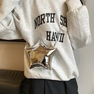 Silver metallic star-shaped crossbody bag with mirror finish and slim chain strap