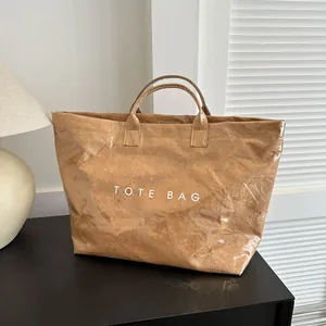 Brown glossy waterproof Tyvek tote bag with white TOTE BAG print and natural crinkle texture