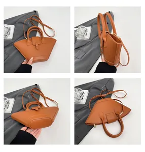 Macro view of caramel brown fan-shaped handbag featuring textured leather and sleek strap