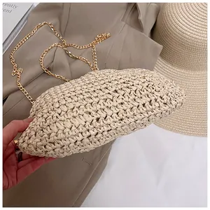 Detail of cream woven straw handbag with elegant gold chain strap for beach vacations