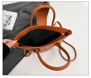 Internal structure of the caramel leather bag showing main compartment and phone pocket
