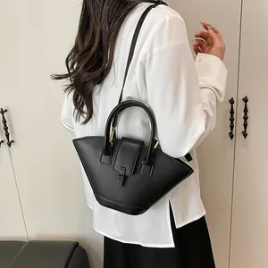 Chic black fan-shaped handbag with golden hardware shown as a crossbody bag for women