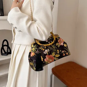 Retro bamboo handle shell bag with floral embroidery and elegant tassel chain strap