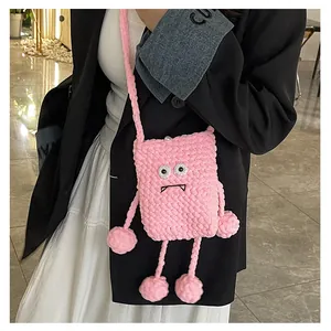 Pink knitted crossbody bag detail with cute monster eyes and pearl clasp fastener