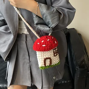 Cute handmade crochet mushroom crossbody bag with red polka dot cap and white knit strap
