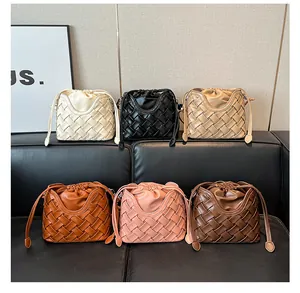 Différentes couleurs de sacs seaux tressés avec cordon de serrage sur canapé