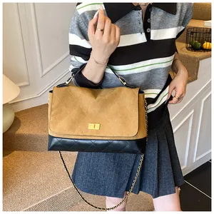 Chic quilted crossbody bag featuring brown suede and black leather panel contrast