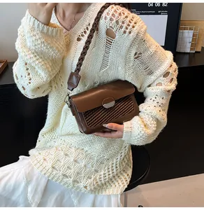 Detail of brown crossbody bag featuring woven texture and thick braided shoulder strap