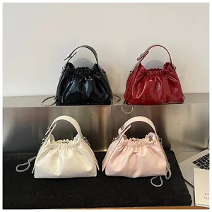 Primer plano de la textura de charol brillante y cadenas metálicas en cuatro bolsos de moda