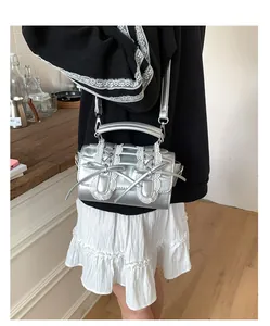 Detalle del bolso plateado con encaje blanco y lazo de estilo lolita muy femenino