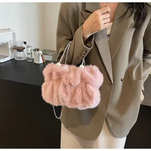 Detailed close-up of pink fluffy cloud bag with pearl handle and metal chain strap