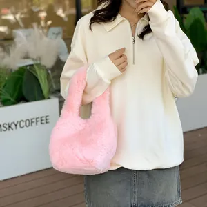 Pink plush faux fur tote bag with a soft fluffy texture for casual autumn fashion style