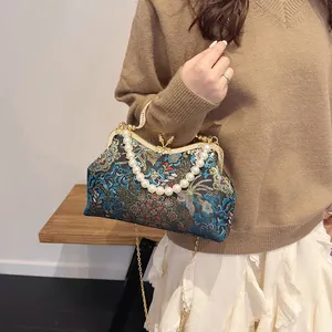 Floral embroidered shell handbag with pearl handle and golden chain strap in retro style
