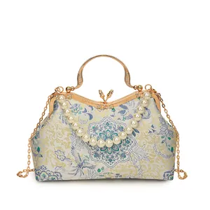 Elegant Chinese shell bag with floral embroidery, pearl handle and gold chain strap