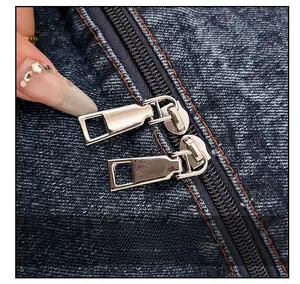 Detail view of smooth double-ended metal zippers on vintage jacquard denim tote bag