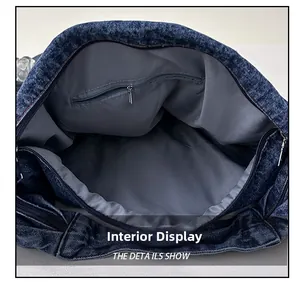 Internal view of denim tote bag showing grey fabric lining and zipper pocket