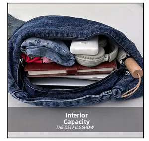 Internal capacity of denim tote bag showing laptop, tablet, and travel essentials