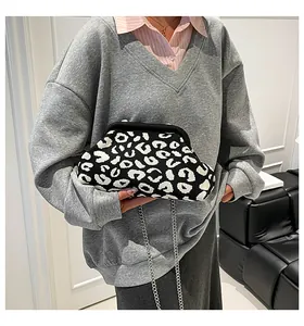 Detalle de bolso nube de punto con estampado de leopardo y cadena plateada en modelo