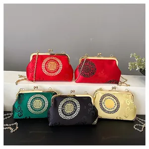 Close-up of traditional Chinese silk embroidery shells bags with gold chain straps