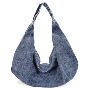 Retro denim hobo tote bag with wide shoulder strap in a washed blue vintage aesthetic