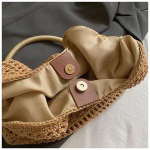 Detail of beaded tote bag interior showing fabric lining and secure metal magnetic clasp