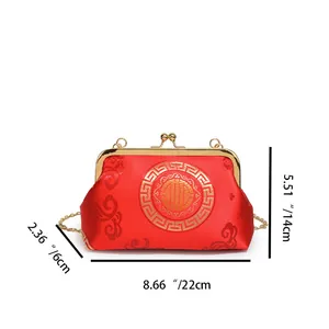 Macro detail of the Chinese style red satin evening bag showing embroidery and 22cm length