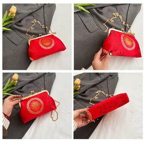 Detailed views of red satin shell bag with gold embroidery and metal chain strap