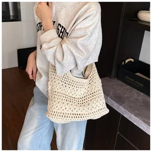Detailed crochet texture with floral patterns on a large cream woven beach tote bag
