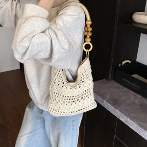 Beige crochet hollow-out floral tote bag with wooden bead straps for beach vacations