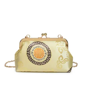 Golden Chinese style shell bag with embroidery and circular pattern for evening events