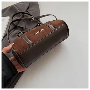 Detalle del bolso cilíndrico PANTOOR que muestra la textura de gamuza y el logo