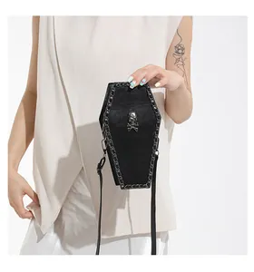 Detailed view of Gothic coffin-shaped crossbody bag with metal skull and chain accents