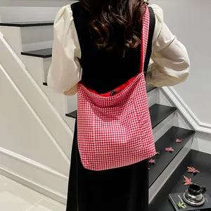 Bolso tote a cuadros rojos y blancos con forro de felpa mostrado en una escalera blanca