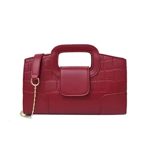 Chic red faux crocodile leather handbag with elegant gold chain strap and top handle