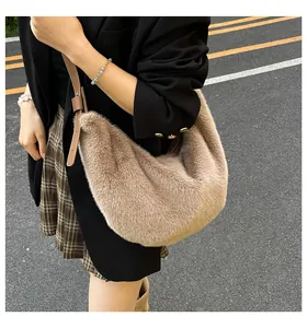 Photo lifestyle d'un sac hobo en peluche kaki porté en bandoulière par un mannequin