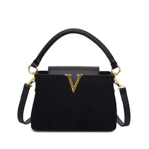 Classic black suede shoulder bag with gold V-hardware and smooth leather top handle