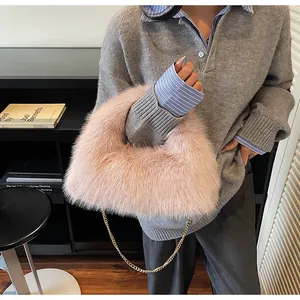 Détail du sac à main en fausse fourrure rose avec bandoulière chaîne dorée