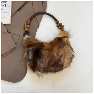 Detailed close-up of brown faux fur underarm bag with vintage wooden bead handle detail