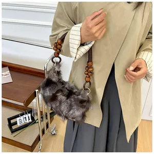 Detail of plush faux fur shoulder bag with vintage dark brown wooden bead handle