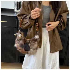 Detail of color-block fox fur handbag with wooden beads and woven shoulder handle