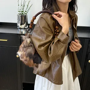 Faux fur patchwork underarm bag with vintage beaded handle and textured brown finish