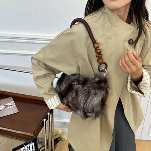 Brown faux fox fur shoulder bag with vintage wooden beads and braided handle detail