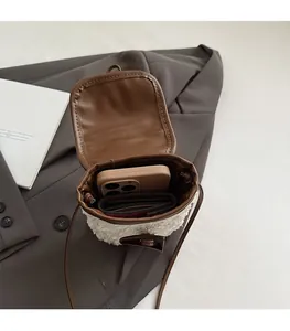 Interior view of fuzzy shearling crossbody bag showing space for phone and wallet