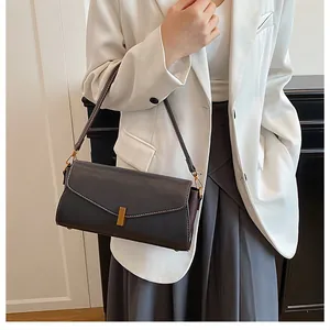 Detailed view of vintage lychee texture leather underarm bag with gold metal buckle