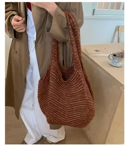 Detailed texture of brown knit tote bag with V-pattern and soft fuzzy material